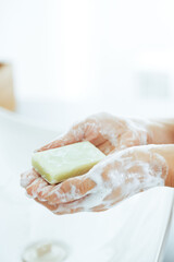 Wall Mural - Closeup on young woman washing hands