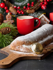 Canvas Print - Christmas pastries stollen sprinkled with powdered sugar on the table, festive dessert