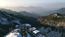 Aerial View Of Beautiful Snow-covered Mountains During Winters In The Himalayan Region Of Uttarakhand. First Snowfall In Dhanaulti, India. Hill Station Covered In Snow. Foothills Of Himalayas.