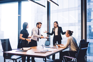 Wall Mural - Full length view of business people collaborating around table