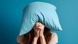 photo of woman covering her face with pillow
