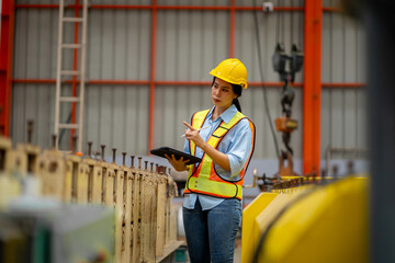 Young female engineer in metal sheet factory Responsible work is being inspected at the actual work site