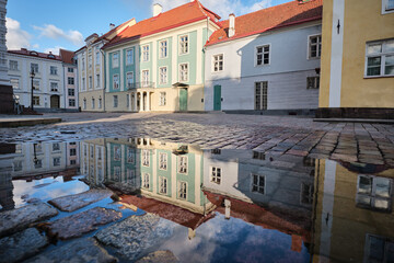 Wall Mural - A reflection of a building in a puddle of water. Tallinn city, Estonia.