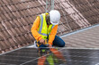 © NewSaetiew - Service engineer installing solar cell on the roof of house. Technicians working about solar panel system outdoors. Clean and Renewable energy concept.