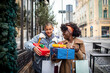 © Marko Geber - Lesbian couple excitedly exchanges gifts on a city street