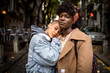 © Marko Geber - Portrait of lesbian couple hugging each other on a city street