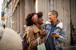 © Marko Geber - Lesbian couple sharing a joyous moment on a city street