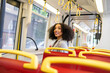 © ADDICTIVE STOCK - Young afro woman on bus