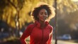Young African American woman is jogging outside