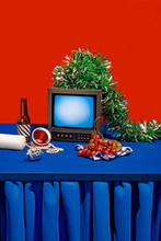 Retro TV On Placed On Blue Table Against Red Background