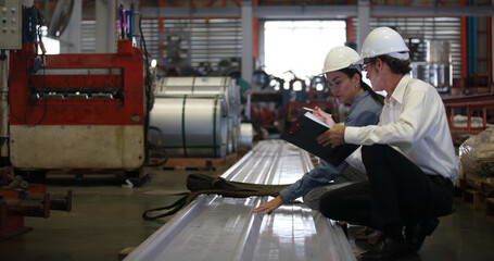 Wall Mural - worker or engineer working in factory with safety uniform , safety hat and safety glasses , image is safety concept or happy workplace