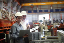 Worker Or Engineer Working In Factory With Safety Uniform , Safety Hat And Safety Glasses , Image Is Safety Concept Or Happy Workplace