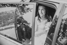 The Bride Is Sitting In The Car, The Groom's Reflection In The Window