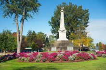 The Civil War Memorial In The Town Square At Twinsburg, Ohio, Surrounded By Clusters Of Vibrant Petunias.