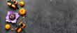 © Pixel-Shot - Composition with delicious chocolate pumpkin, gifts and decor for Halloween celebration on dark background with space for text