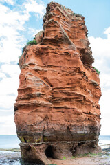 Wall Mural - Rock formations in Ladram Bay, United Kingdom. View of the beach and red and orange cliffs and the sea, Jurassic coast, selective focus