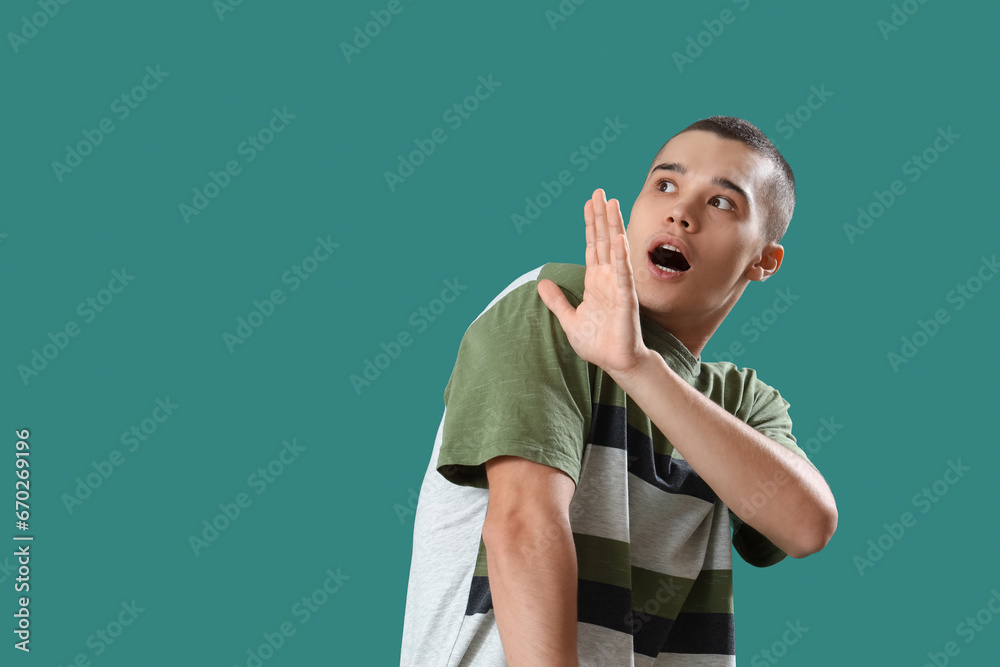 Afraid young man on green background