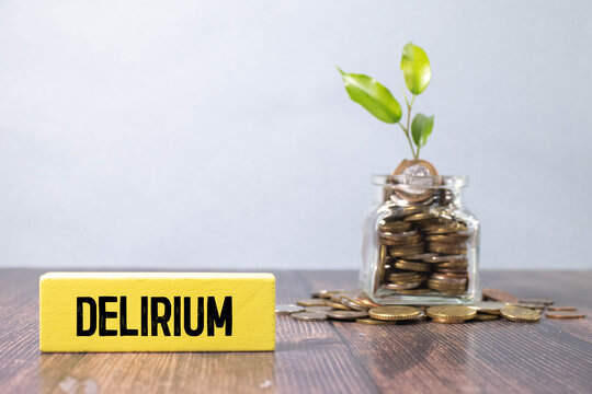 word delirium made of wooden letters on a gray table on a green background