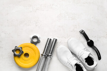 Barbell plates, shoes, watches, grips and clamps on white background