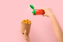Woman Holding Paper Bucket With Tasty Nuggets And Ketchup On Pink Background