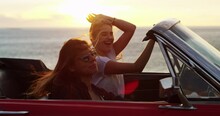 Women on road trip with car, ocean and excited in freedom, nature and dancing on sunset holiday. Happy travel friends in convertible, adventure and journey at beach with fun drive, relax and laugh.