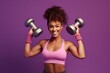 home training fitness background purple isolated vest casual pink wears broadly smiles mat fitness rolled holds biceps shows dumbbell hand raises woman skinned dark happy funny   active afro