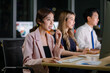 © Bangkok Click Studio - Asian professional successful female businesswomen assistant night shift call center helpline in formal business outfit and microphone headphones sitting smiling talking helping customers online