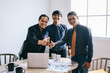© Queenmoonlite Studio - Group of Asian businessman in formal suits showing thumbs up after meeting in office