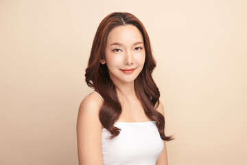 Wall Mural - Beautiful young asian woman with clean fresh skin on beige background, Face care, Facial treatment, Cosmetology, beauty and spa, Asian women portrait.