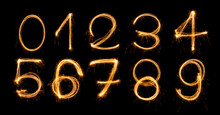 Fireworks Numbers 0-9 Burning Sparkler Numbers Isolated On Black Background. Sparkler Firework Light Alphabet Number Zero To Nine. Numbers Alphabet Of Sparklers To Overlay On Texture For Happy Design