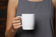 © Rytis - Commercial, industry, fashion and style, drinks and beverages concept. Woman hands holding white blank with copy space mug or cup of coffee or tea