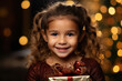 cute little girl holding gift box in hand