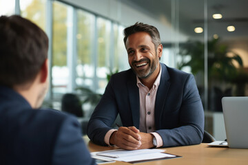 indian businessman being interviewed at his new car dealership