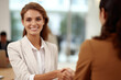 © vefimov - Professional woman shaking hands with man in suit. This image can be used to depict business meeting, networking event, or partnership agreement.