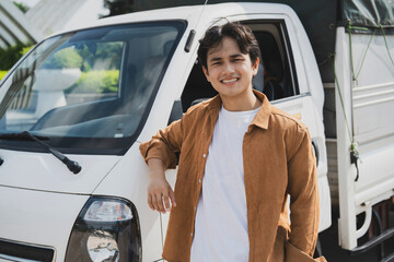 Canvas Print - Photo of young Asian man with his truck