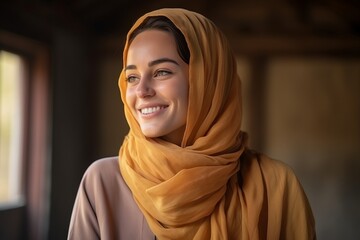 Portrait of beautiful young muslim woman in hijab smiling at camera