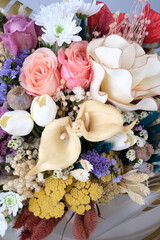 Prompt Engagement Bouquet. Wedding flowers close-up. Decoration of roses, flowers and ornamental plants, close-up, selective focus, nobody, objects. Luxury artificial bouquet of colorful flowers for b