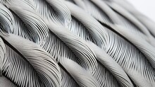 A Close-up Of The Intricate Patterns On A Guinea Fowl Feather, Contrasted Against A White Surface.