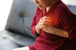 A senior woman has sudden chest pain in her home, heart disease and asthma patients.
