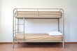 © Alfazet Chronicles - isolated metal bunk bed with thin mattresses in a beige room