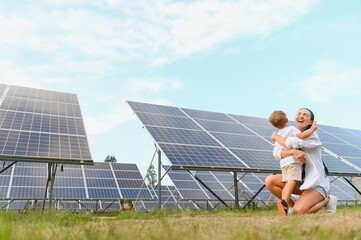 Mother with her little son by solar panels