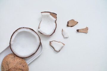 Sticker - Fresh coconut and white ceramic plate on minimalist background. Scenes for advertising products with natural origins. View from above, flat lay.