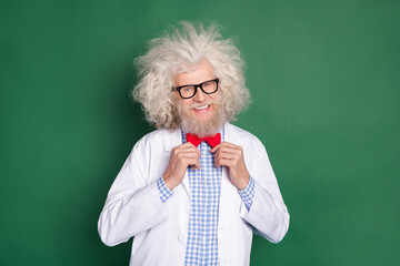 Wall Mural - Photo of funky funny positive good mood crazy scientist with messy hair correct red bow tie isolated on green color background