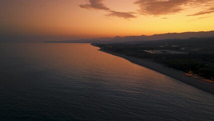 Wall Mural - Sunset sky And silhouette of Calabrian coast near the sea