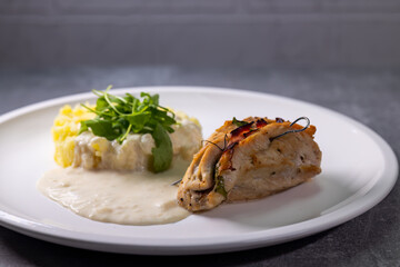 Wall Mural - turkey roll filled with spinach and ham served with mashed potatoes and cream sauce