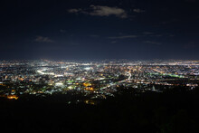 Chiang Mai Night City View From The Slopes Of Doi Pui Mountain On The Way To The Famous Doi Suthep Temple, North Thailand.