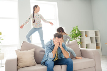 Sticker - Photo of displeased exhausted guy hands cover face cheerful girls siblings playing make noise home indoors