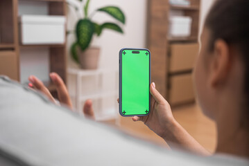Aufkleber - woman online call with doctor on her smartphone with chroma key screen, waving hand, consultation online at home