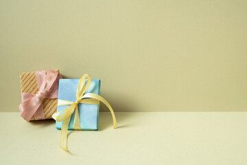 Wall Mural - Two gift boxes on table. khaki beige background