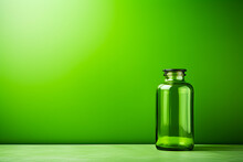 Green Glass Bottle Sitting On Top Of Table Next To Green Wall.